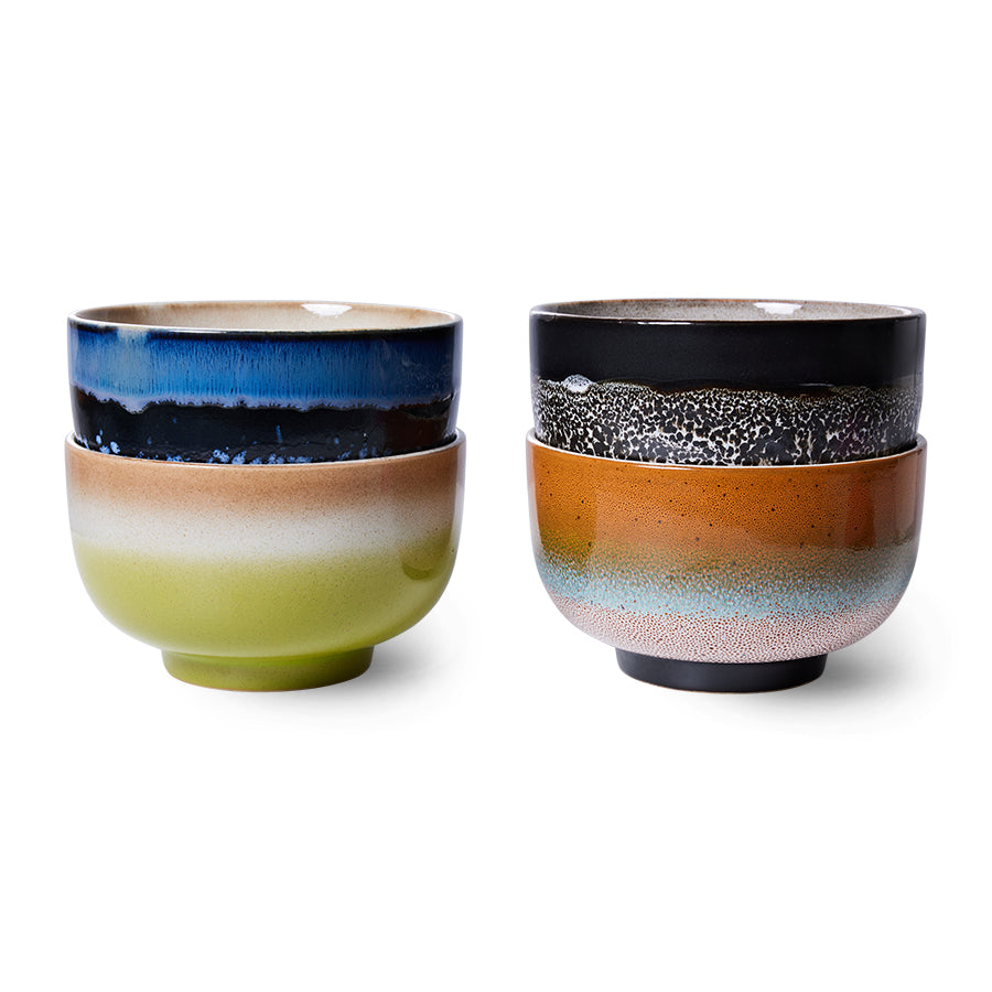 Two sets of ceramic bowls with multicolored glazes on a white background