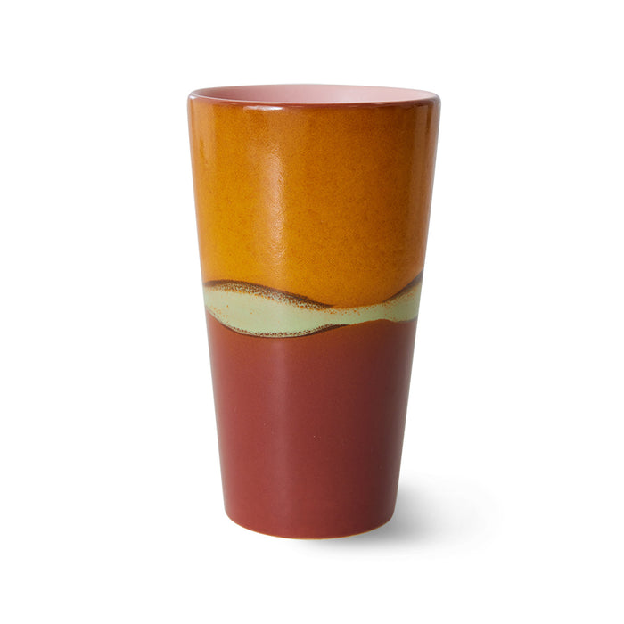 Ceramic tumbler with gradient color design on a white background