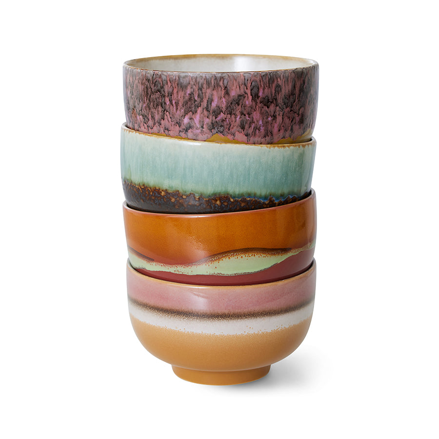Stack of colorful ceramic cups on a white background