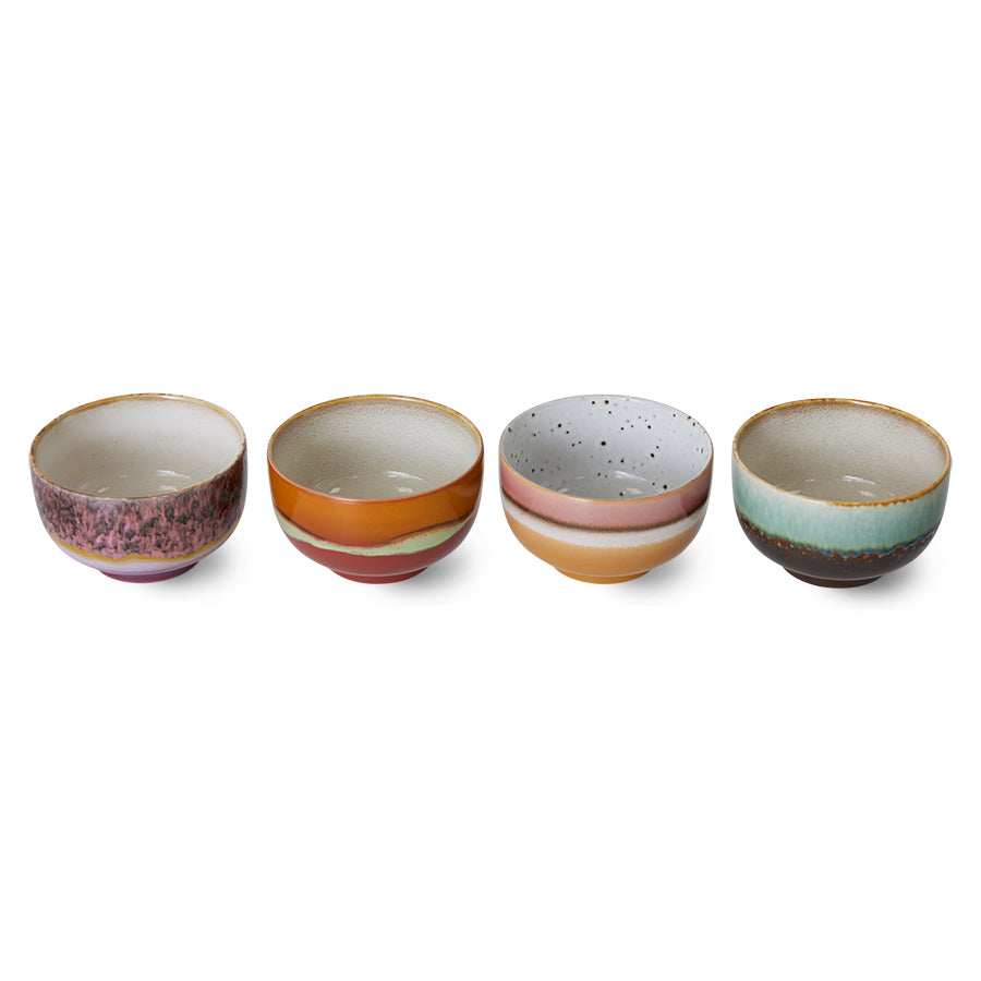 Set of four colorful ceramic bowls on a white background