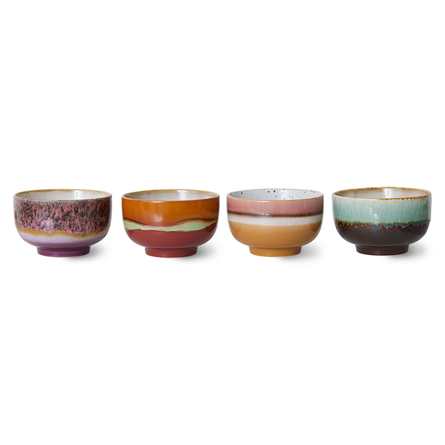 Set of four ceramic bowls with multicolored glaze on a white background