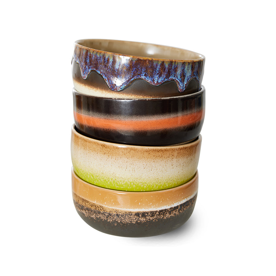 Stack of ceramic cups with multicolored glaze on a white background