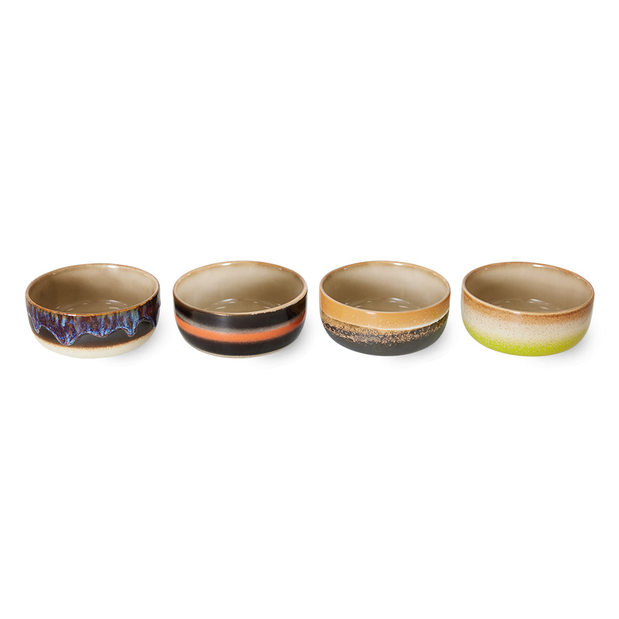Four ceramic bowls with gradient colors on a white background
