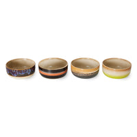 Four ceramic bowls with gradient colors on a white background
