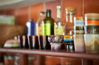 Assorted bottles and containers on a shelf with a blurred background