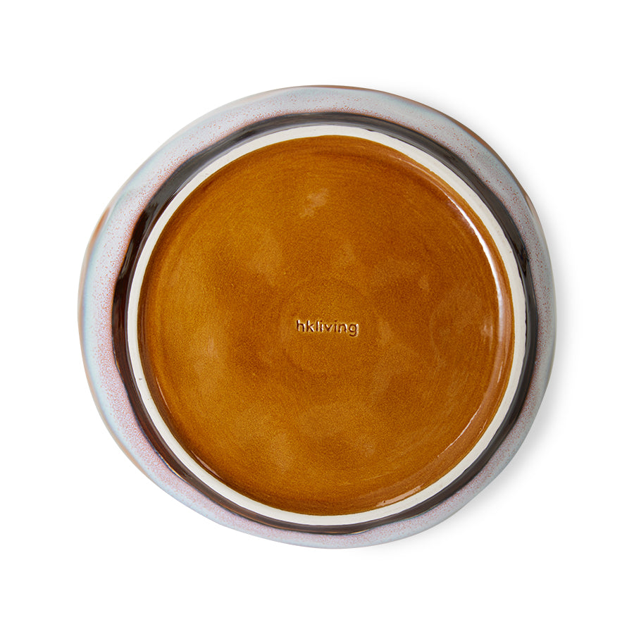 Round brown ceramic dish with silver rim on a white background
