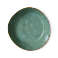 Green ceramic plate on a white background