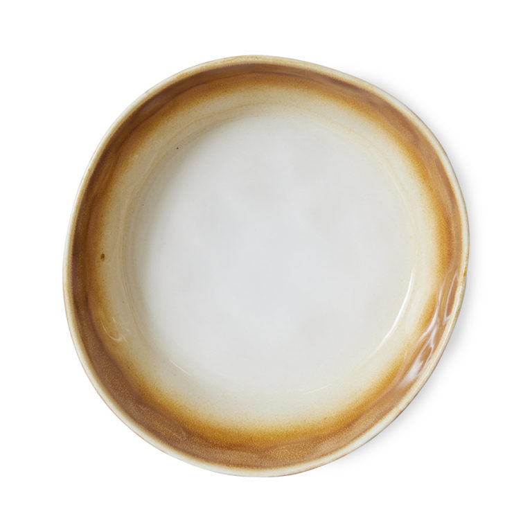 Round ceramic plate with brown rim on a white background