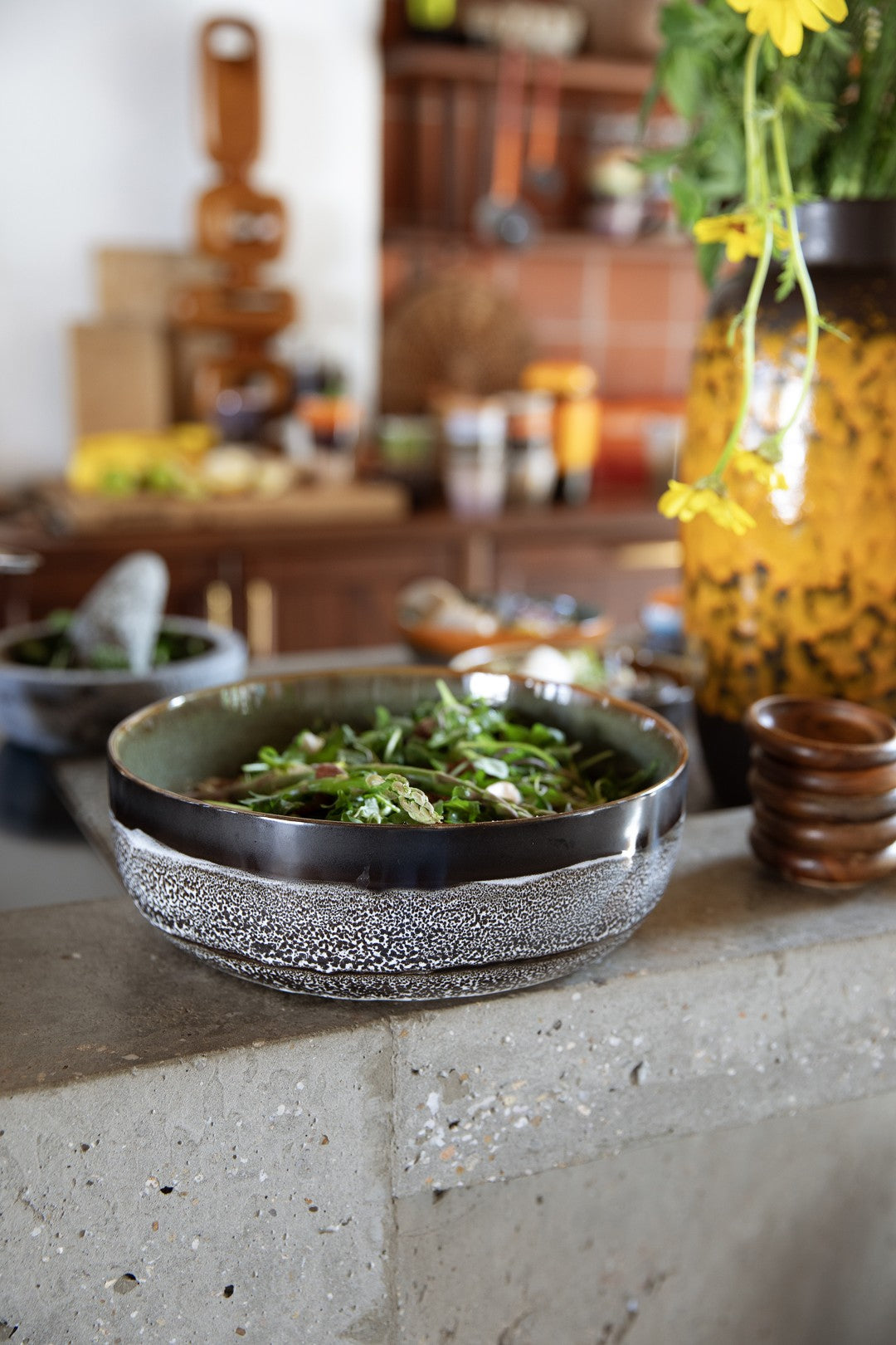 Bowl of salad on a kitchen counter with blurred background