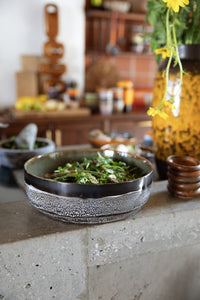 Bowl of salad on a kitchen counter with blurred background