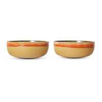 Two ceramic bowls with a beige body and orange rim on a white background