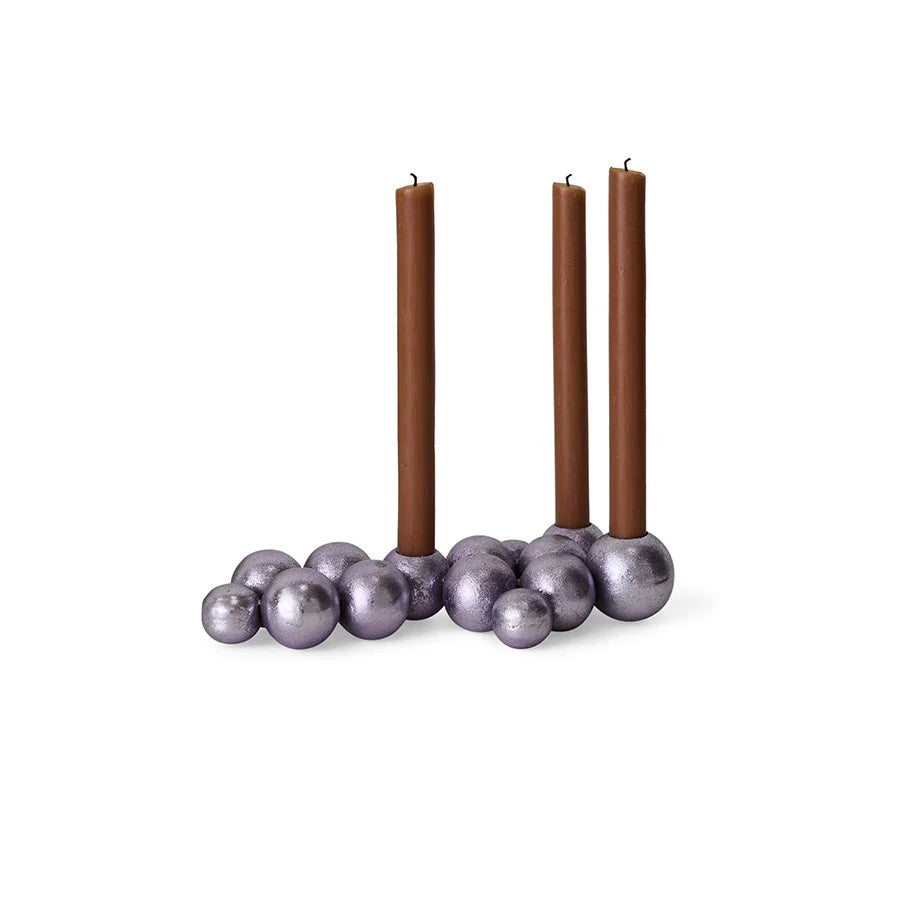 Candle holder with three brown candles on a white background