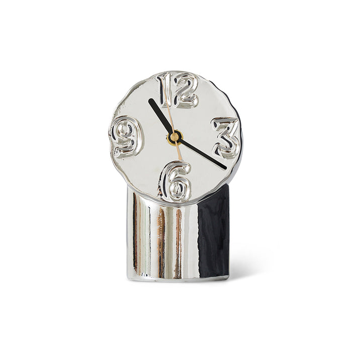 Silver clock with black hands on a white background