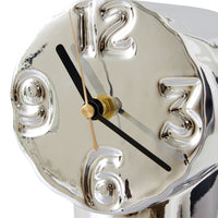 Silver clock with black and gold hands on a white background