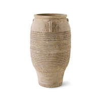 Beige ceramic vase with ribbed texture on a white background