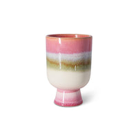 Ceramic cup with multicolored stripes on a white background