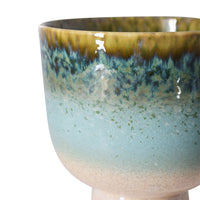 detail of blue ceramic flower pot on white background