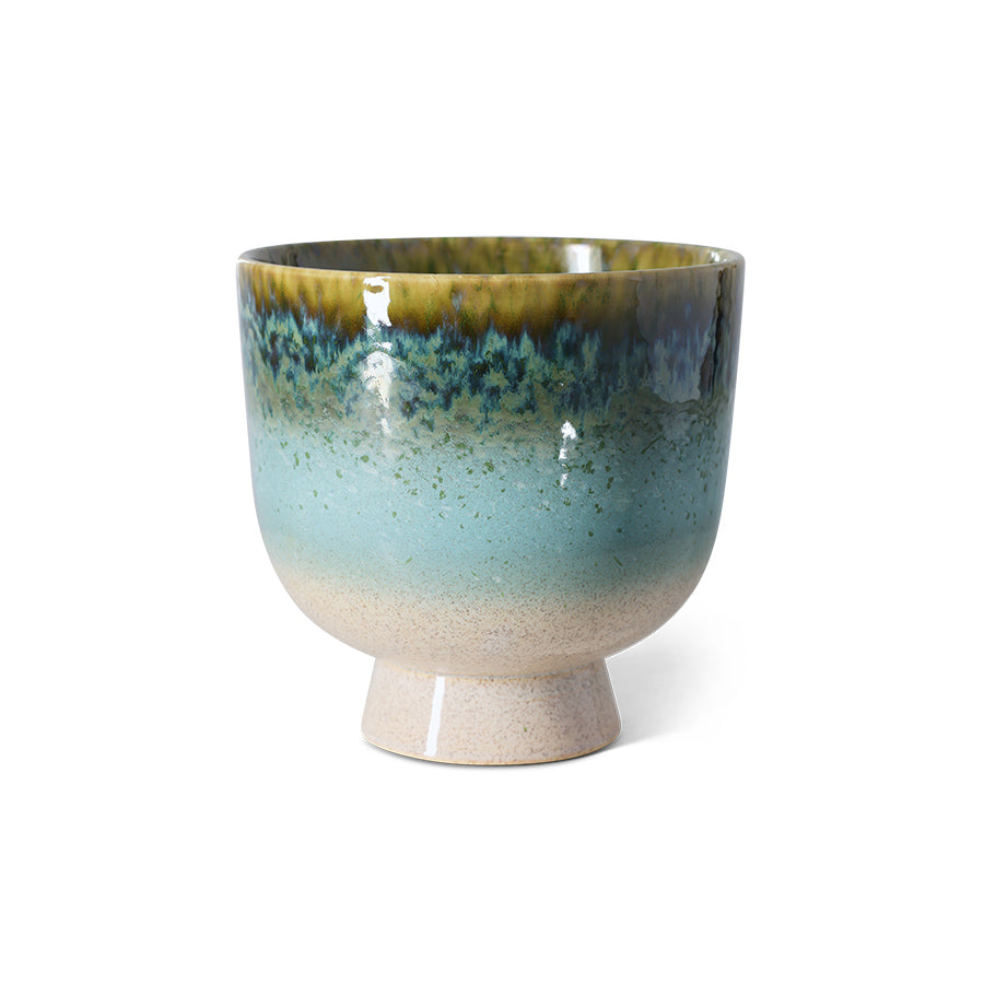 Ceramic footed bowl with gradient blue and green glaze on a white background