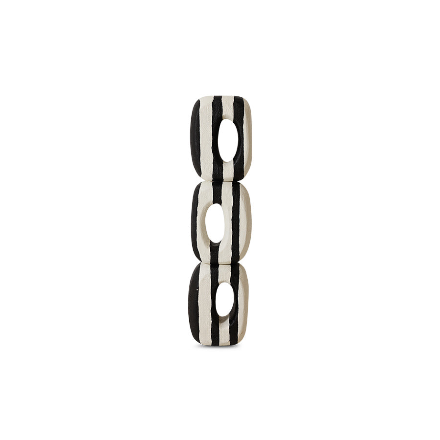 Black and white striped cylindrical object on a white background