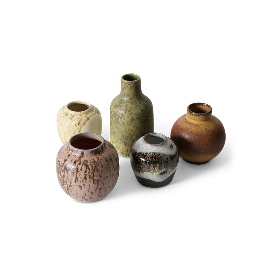 Set of five ceramic vases with different textures and colors on a white background