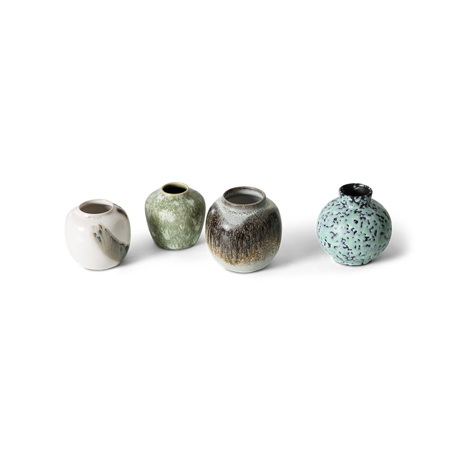 Four ceramic vases with different textures and colors on a white background