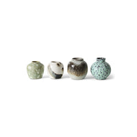 Four ceramic vases with textured finishes on a white background