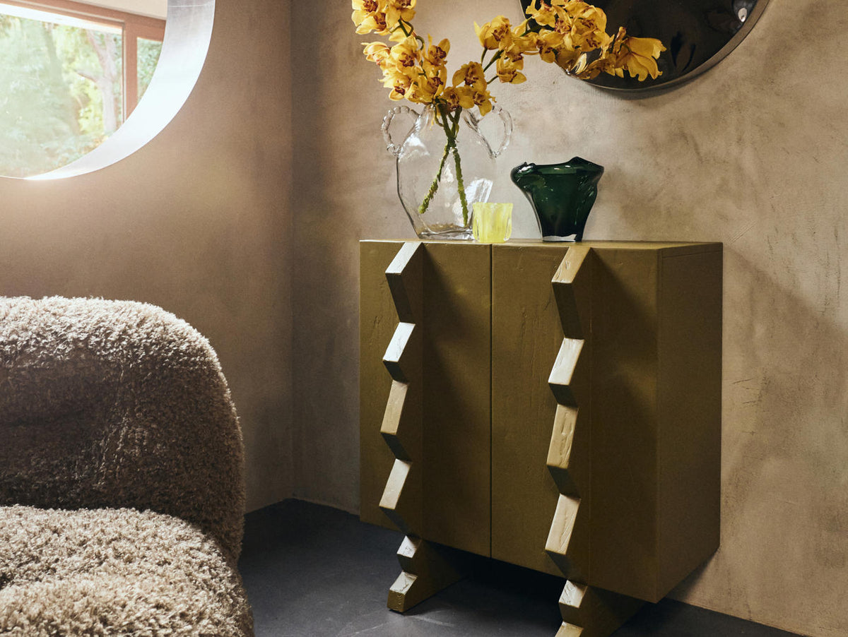 Modern side table with decorative items in a room setting