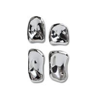Set of four silver sculptures on a white background
