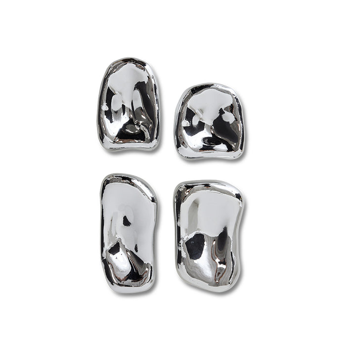 Set of four silver sculptures on a white background