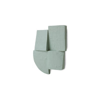 green textured wall sculpture on a white background