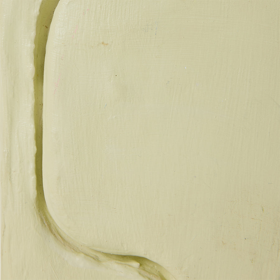 Close-up of a greenish-brown stain on beige fabric