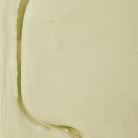 Close-up of a greenish-brown stain on beige fabric