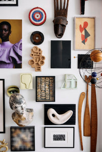 Wall with various decorative items including sculptures, paintings, and abstract art.