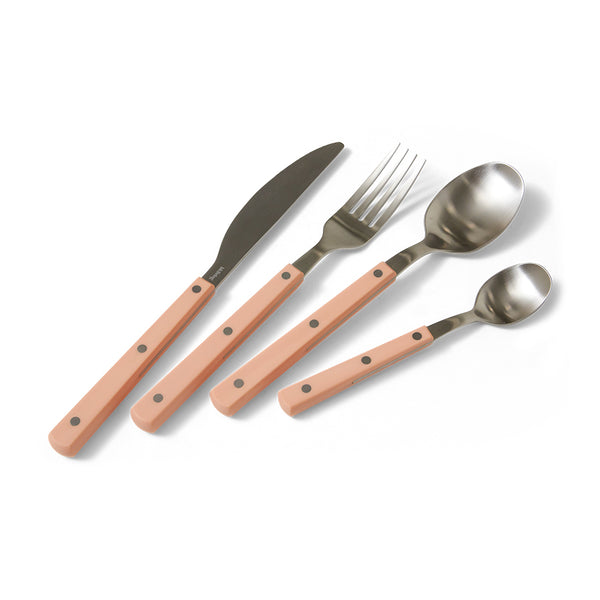 Set of cutlery with pink handles on a white background