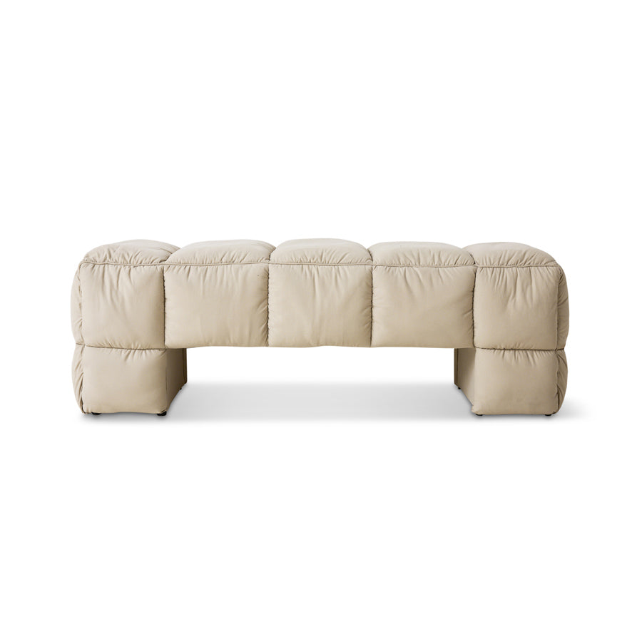 Beige quilted sofa on a white background