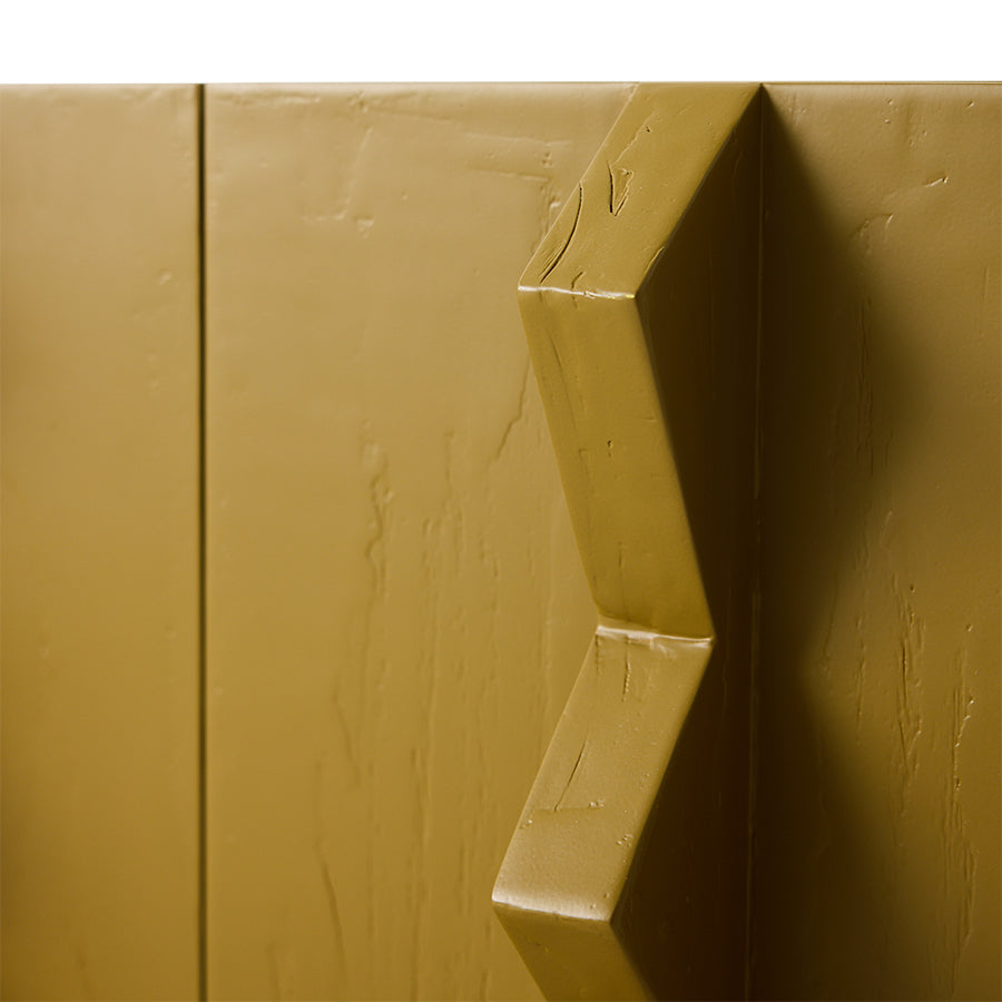 detail of olive green wooden cabinet with sculptural handles