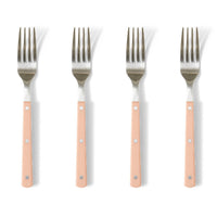 Four forks with pink handles on a white background