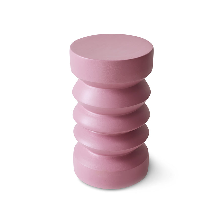 Pink cylindrical stool with layered design on a white background
