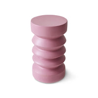 Pink cylindrical stool with layered design on a white background