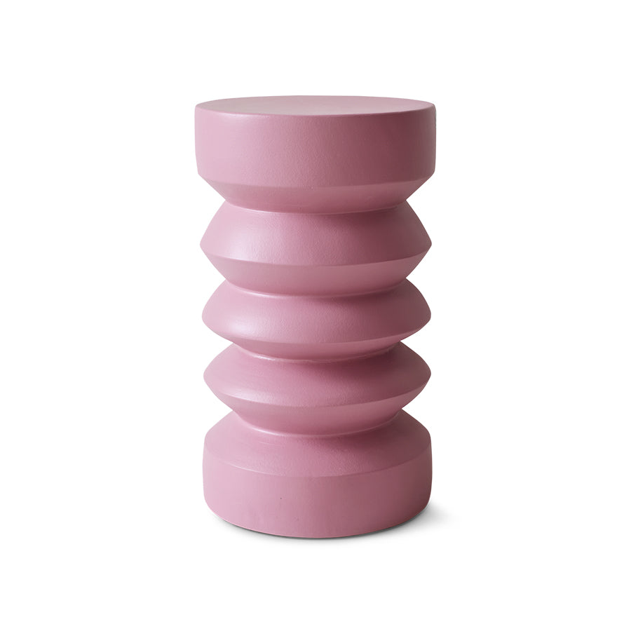 Pink cylindrical vase with stacked design on a white background