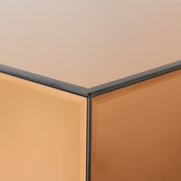 Close-up of a corner where two beige walls meet with a black trim.