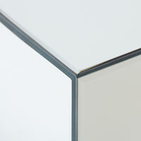 Close-up of a corner of a mirror block coffee table