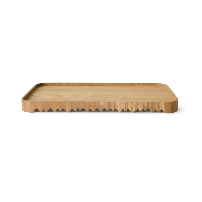 Wooden serving tray board with wavy edge on a white background