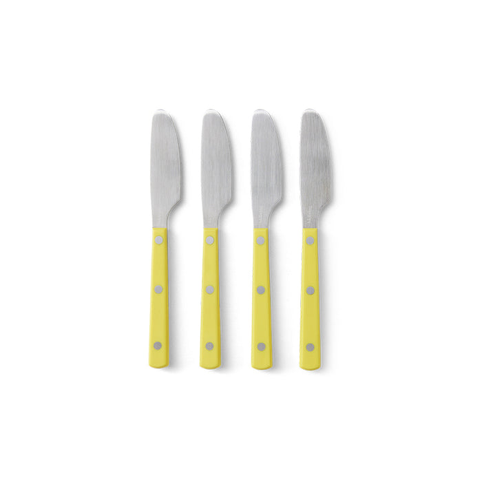 Four butter knives with yellow handles on a white background