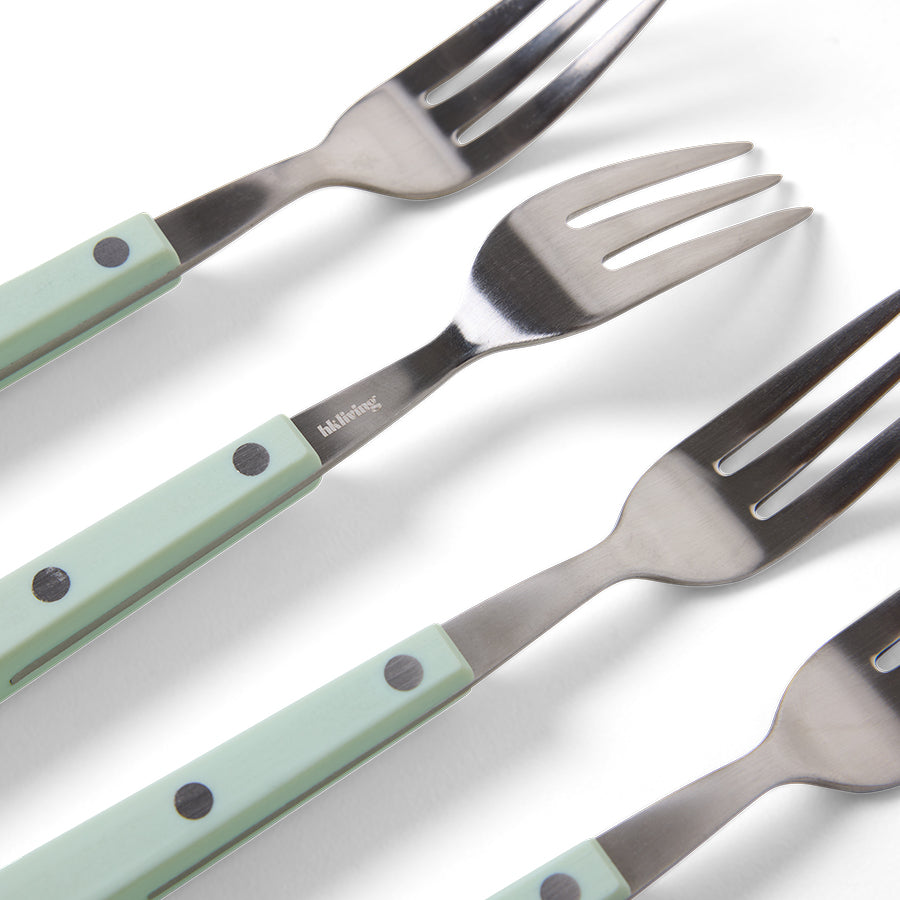 Set of four forks with light green handles on a white background