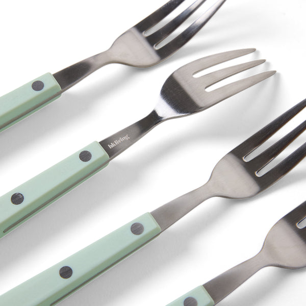 Set of four forks with light green handles on a white background