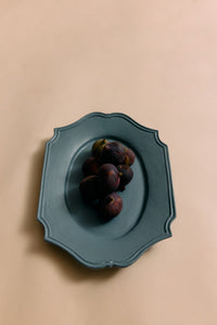 Blue plate with figs on a beige background