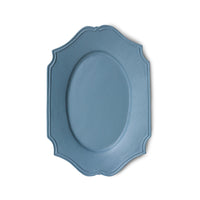 Blue oval plate with decorative edge on a white background