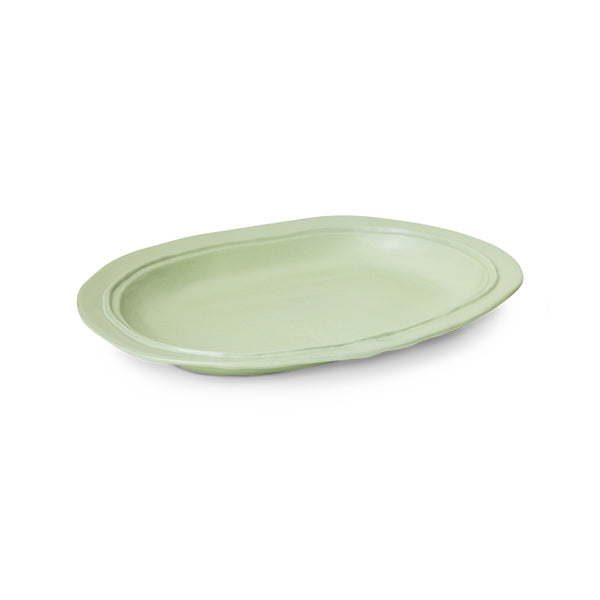 Green ceramic plate on a white background