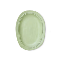 Green oval plate on a white background